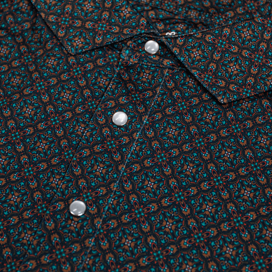 Close-up of the Pearl Snap Polo by Iron Oak Apparel, showcasing its intricate geometric pattern and signature pearl snap buttons. This stylish shirt combines modern design with Texan authenticity, perfect for elevating casual outfits.
