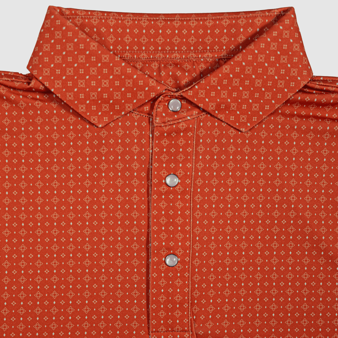 Flat lay of The Boone Pearl Snap Polo by Iron Oak Apparel, featuring a burnt orange western pattern and signature pearl snap buttons. This stylish shirt combines modern design with Texan authenticity, perfect for any casual or dressy occasion.