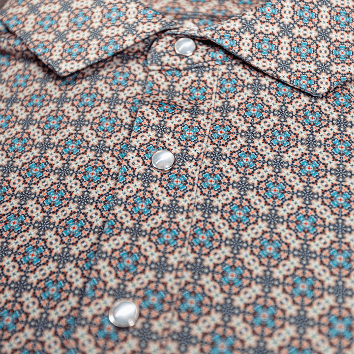 Detailed view of the pearl snap buttons and geometric western pattern on The Jaded Pearl Snap Polo by Iron Oak Apparel.