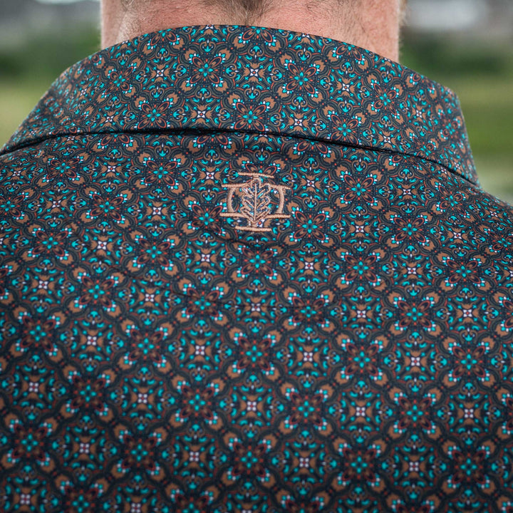 Close-up of the back of a Pearl Snap Polo by Iron Oak Apparel, highlighting the detailed western pattern and the embroidered logo. This stylish and comfortable shirt embodies modern Texan fashion, perfect for any casual occasion.