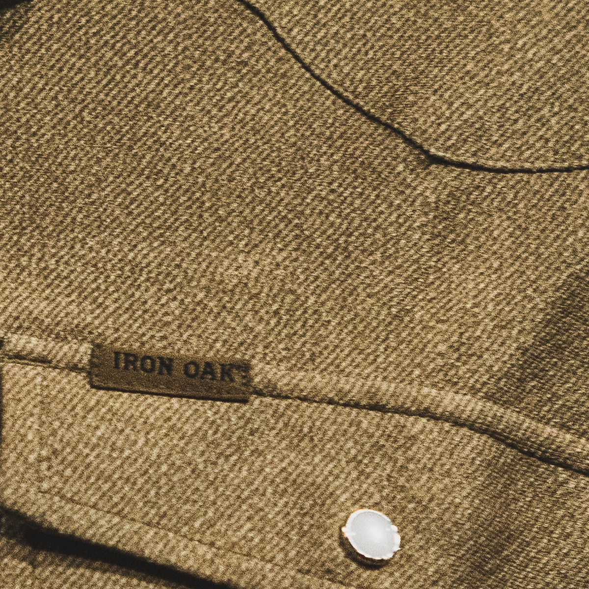 Close-up of the Dusty's golden brown jacquard texture and pearl-snap chest pocket