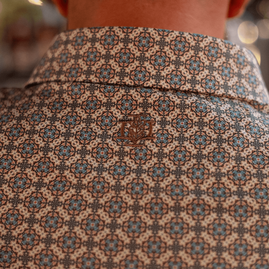 Back view of The Jaded Pearl Snap Polo by Iron Oak Apparel, highlighting the intricate pattern and embroidered Iron Oak logo.