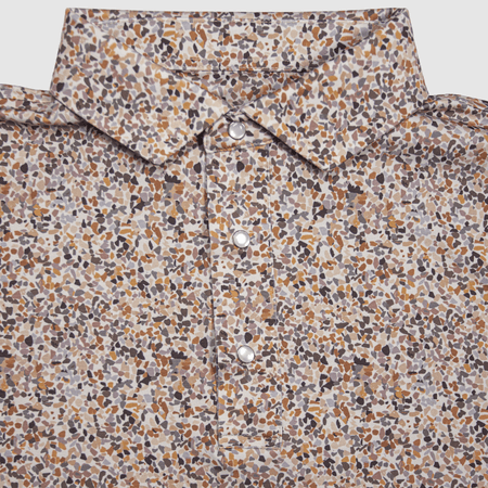  Flat lay of the CamOAK Pearl Snap Polo by Iron Oak Apparel, featuring a unique camouflage pattern with earthy tones and signature pearl snap buttons. This stylish shirt combines modern design with Texan authenticity, perfect for outdoor adventures.