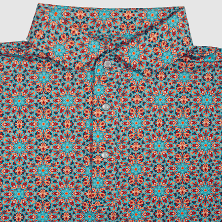 Flat lay of The Clementine Pearl Snap Polo by Iron Oak Apparel, featuring a vibrant geometric western pattern with turquoise and orange accents. This stylish shirt blends modern design with Texan authenticity, perfect for any occasion.